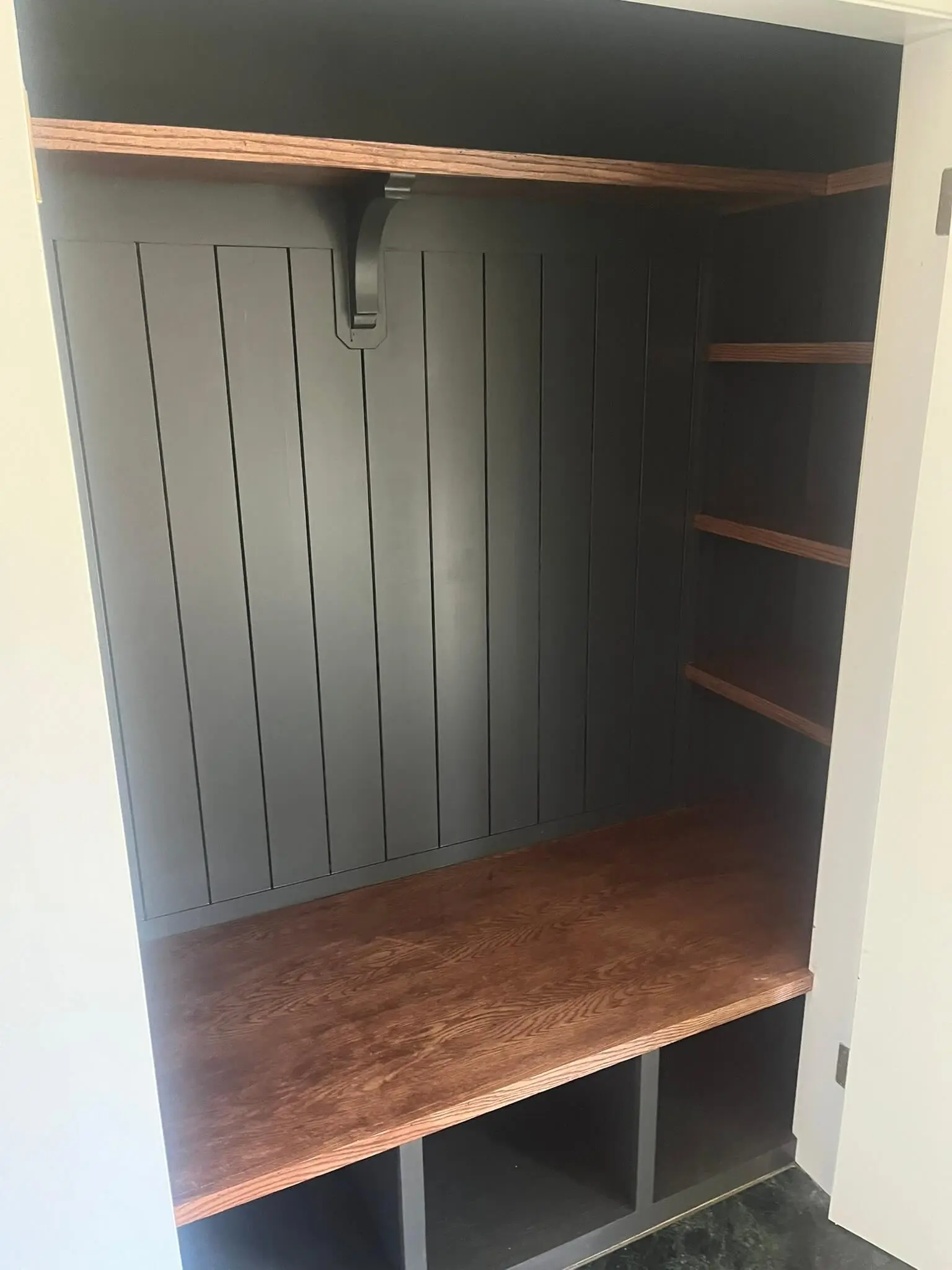 A closet with stained shelves